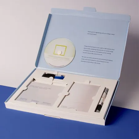 Book-style PR box opened to show a printed message and fitted items